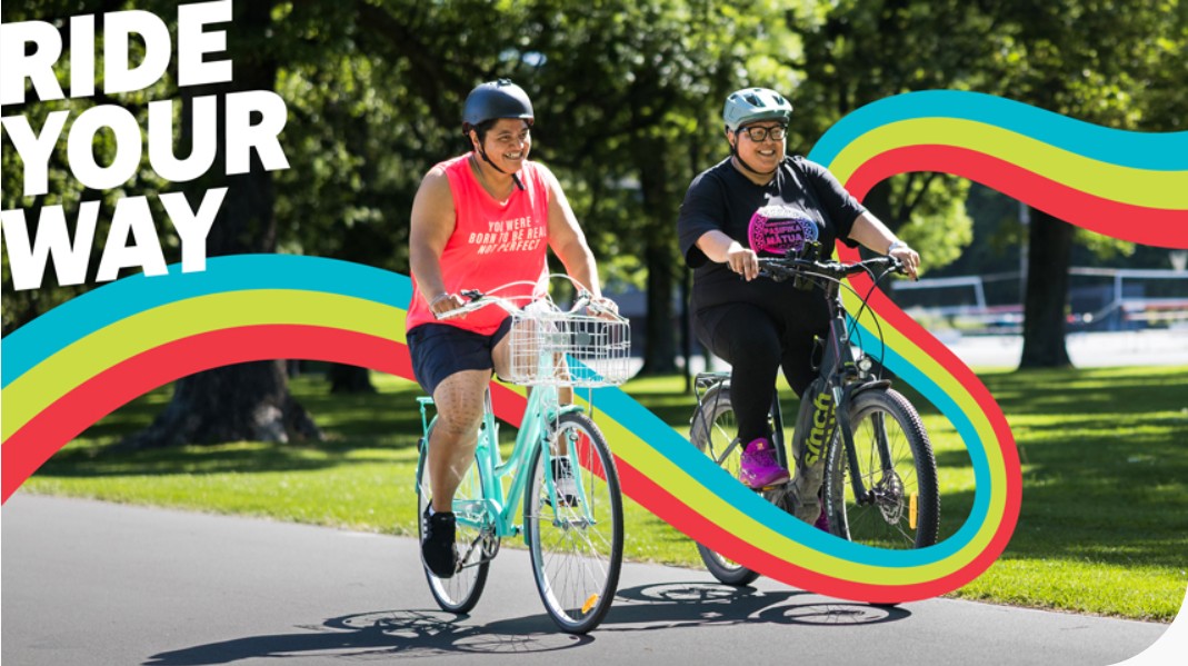 An of two people bikins along a cycleway